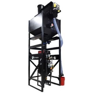 A large, industrial black metal machine with a tall frame, a Media Storage Hopper at the top, pipes, valves, and a control panel—ideal for Pressure Blasters—stands against a plain white background.